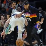 
              Phoenix Suns center JaVale McGee (00) pushes past Dallas Mavericks guard Luka Doncic, left, for a loose ball during the second half of Game 1 in the second round of the NBA Western Conference playoff series Monday, May 2, 2022, in Phoenix. (AP Photo/Matt York)
            