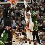 
              Boston Celtics guard Jaylen Brown (7) blocks a shot to the basket by Miami Heat center Bam Adebayo (13) during the second half of Game 1 of an NBA basketball Eastern Conference finals playoff series, Tuesday, May 17, 2022, in Miami. (AP Photo/Lynne Sladky)
            