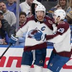 
              Colorado Avalanche's Gabriel Landeskog, left, is congratulated by teammate Nathan MacKinnon (29) after scoring during the third period in Game 3 of an NHL hockey Stanley Cup second-round playoff series against the St. Louis Blues Saturday, May 21, 2022, in St. Louis. (AP Photo/Jeff Roberson)
            