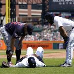 
              Cleveland Guardians first baseman Josh Naylor, left, and Detroit Tigers' Derek Hill look over Tigers first base coach Gary Jones after Jones was hit by a foul line drive during the third inning of a baseball game, Sunday, May 29, 2022, in Detroit. (AP Photo/Carlos Osorio)
            
