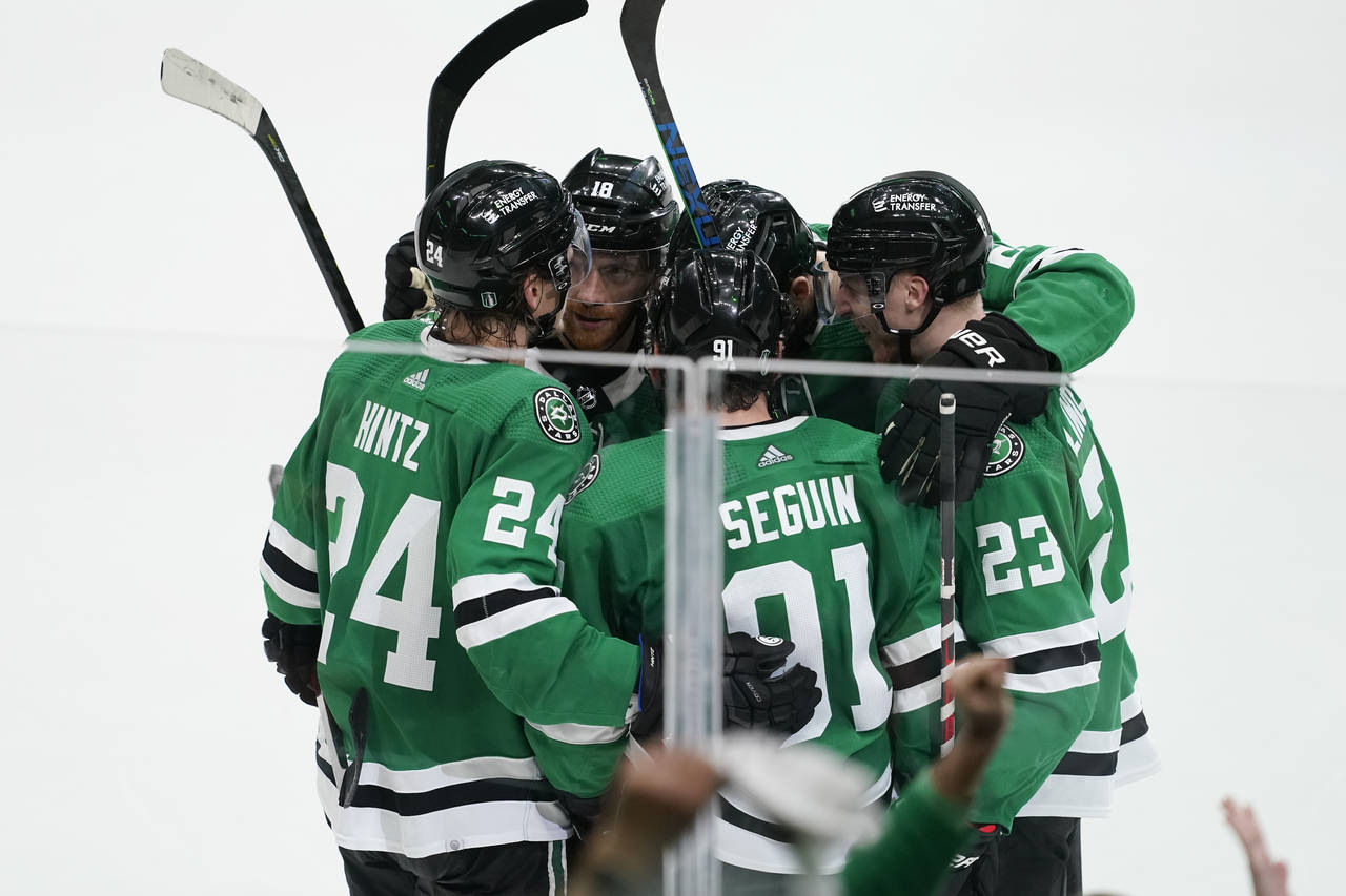 Dallas Stars players celebrate an open net goal by Tyler Seguin (91) during the third period of Gam...