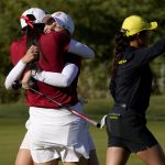 
              Stanford golfer Brooke Seay, center, hugs a teammate after winning her match on the 15th green during the NCAA college women's golf championship title match as Oregon golfer Ching-Tzu Chen, right, walks off the green at Grayhawk Golf Club, Wednesday, May 25, 2022, in Scottsdale, Ariz. (AP Photo/Matt York)
            