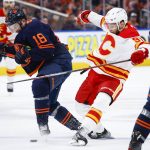 
              Calgary Flames forward Calle Jarnkrok, right, is checked by Edmonton Oilers winger Zach Hyman during the third period of Game 4 of an NHL hockey Stanley Cup playoffs second-round series Tuesday, May 24, 2022, in Edmonton, Alberta. (Jeff McIntosh/The Canadian Press via AP)
            