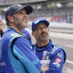 
              Jimmie Johnson, center, and Tony Kanaan, right, of Brazil, look at the speeds during practice for the Indianapolis 500 auto race at Indianapolis Motor Speedway, Sunday, May 22, 2022, in Indianapolis. (AP Photo/Darron Cummings)
            