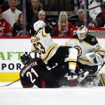
              Carolina Hurricanes' Nino Niederreiter (21) collides with Boston Bruins' Brad Marchand (63) in front of goaltender Linus Ullmark (35) during the first period of Game 1 of an NHL hockey Stanley Cup first-round playoff series in Raleigh, N.C., Monday, May 2, 2022. (AP Photo/Karl B DeBlaker)
            
