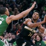 
              Milwaukee Bucks forward Giannis Antetokounmpo, right, is pressured by Boston Celtics forward Grant Williams (12) while lining up a shot in the first half of Game 2 of an NBA basketball Eastern Conference semifinal series Tuesday, May 3, 2022, in Boston. (AP Photo/Charles Krupa)
            