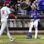 
              New York Mets' Francisco Lindor (12) reacts after hitting a two-run triple, as Philadelphia Phillies third baseman Alec Bohm heads back to his position during the fifth inning of a baseball game Saturday, May 28, 2022, in New York. (AP Photo/Jessie Alcheh)
            