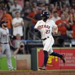 
              Houston Astros' Jose Altuve (27) scores on a triple by Michael Brantley during the eighth inning of a baseball game against the Detroit Tigers Saturday, May 7, 2022, in Houston. (AP Photo/David J. Phillip)
            
