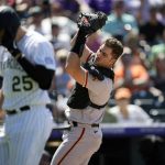 
              San Francisco Giants catcher Joey Bart, right, fields a pop foul off the bat of Colorado Rockies' C.J. Cron in the sixth inning of a baseball game Wednesday, May 18, 2022, in Denver. (AP Photo/David Zalubowski)
            
