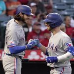 
              Texas Rangers' Mitch Garver, right, is congratulated by Jonah Heim after hitting a solo home run during the fourth inning of a baseball game against the Los Angeles Angels Wednesday, May 25, 2022, in Anaheim, Calif. (AP Photo/Mark J. Terrill)
            