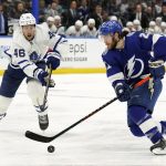 
              Tampa Bay Lightning center Brayden Point (21) gets past Toronto Maple Leafs defenseman Ilya Lyubushkin (46) during the second period in Game 4 of an NHL hockey first-round playoff series Sunday, May 8, 2022, in Tampa, Fla. (AP Photo/Chris O'Meara)
            