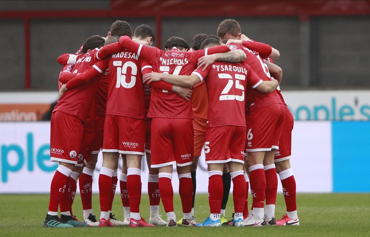 FILE - Crawley Town's players hug each other before the English FA Cup third round soccer match bet...