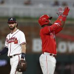 
              Atlanta Braves shortstop Dansby Swanson watches as Philadelphia Phillies Odubel Herrera celebrate his two-run double during the seventh inning of a baseball game Thursday, May 26, 2022, in Atlanta. (Curtis Compton/Atlanta Journal-Constitution via AP)
            