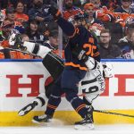 
              Los Angeles Kings' Alex Iafallo (19) is checked by Edmonton Oilers' Darnell Nurse (25) during the first period of Game 2 of an NHL hockey Stanley Cup playoffs first-round series Wednesday, May 4, 2022, in Edmonton, Alberta. (Jason Franson/The Canadian Press via AP)
            