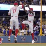 
              Philadelphia Phillies' Rhys Hoskins (17) and Roman Quinn (24) celebrate after the Phillies defeated the Los Angeles Dodgers 8-3 in a baseball game Saturday, May 14, 2022, in Los Angeles. (AP Photo/Mark J. Terrill)
            