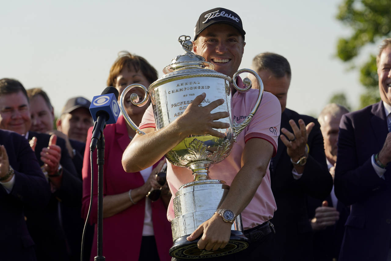 Justin Thomas holds the Wanamaker Trophy after winning the PGA Championship golf tournament in s pl...