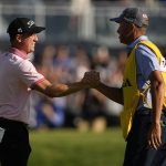 
              Justin Thomas celebrates with his caddie Jim "Bones" Mackay after winning the PGA Championship golf tournament in a playoff against Will Zalatoris at Southern Hills Country Club, Sunday, May 22, 2022, in Tulsa, Okla. (AP Photo/Eric Gay)
            