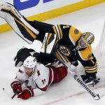 
              Boston Bruins' Jeremy Swayman (1) falls on Carolina Hurricanes' Jordan Staal (11) during the third period of Game 3 of an NHL hockey Stanley Cup first-round playoff series, Friday, May 6, 2022, in Boston. (AP Photo/Michael Dwyer)
            