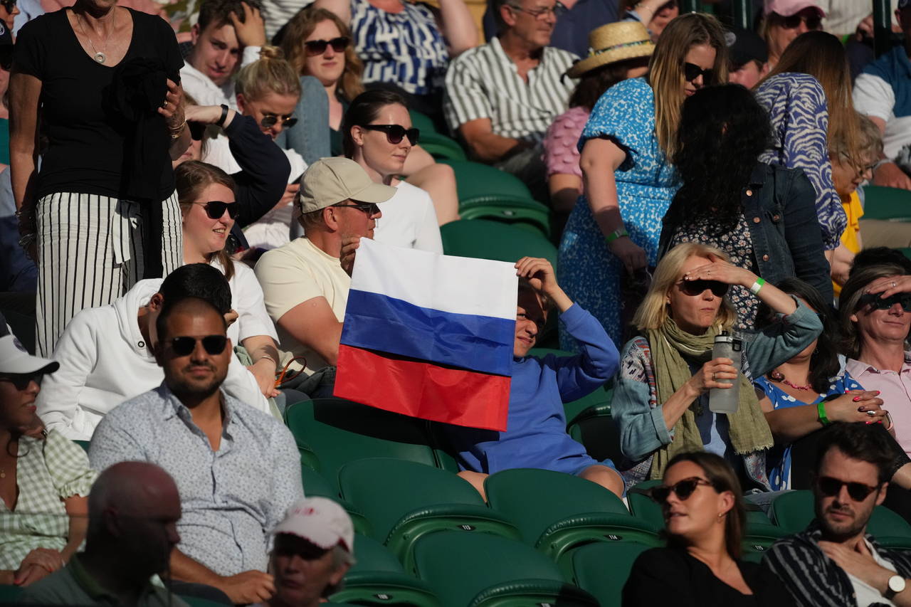 FILE - A spectator holding a Russian flag watches during the men's singles third round match betwee...