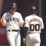 
              San Francisco Giants' Jason Krizan, left, is congratulated by first base coach Antoan Richardson (00) after hitting a single against the Washington Nationals during the fifth inning of a baseball game in San Francisco, Sunday, May 1, 2022. (AP Photo/Jeff Chiu)
            