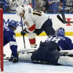 
              Tampa Bay Lightning goaltender Andrei Vasilevskiy (88) and defenseman Mikhail Sergachev (98) team up to stop a shot by Florida Panthers center Aleksander Barkov (16) during the third period in Game 4 of an NHL hockey second-round playoff series Monday, May 23, 2022, in Tampa, Fla. (AP Photo/Chris O'Meara)
            