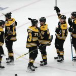 
              The Boston Bruins celebrate after defeating the Carolina Hurricanes in Game 3 of an NHL hockey Stanley Cup first-round playoff series, Friday, May 6, 2022, in Boston. (AP Photo/Michael Dwyer)
            