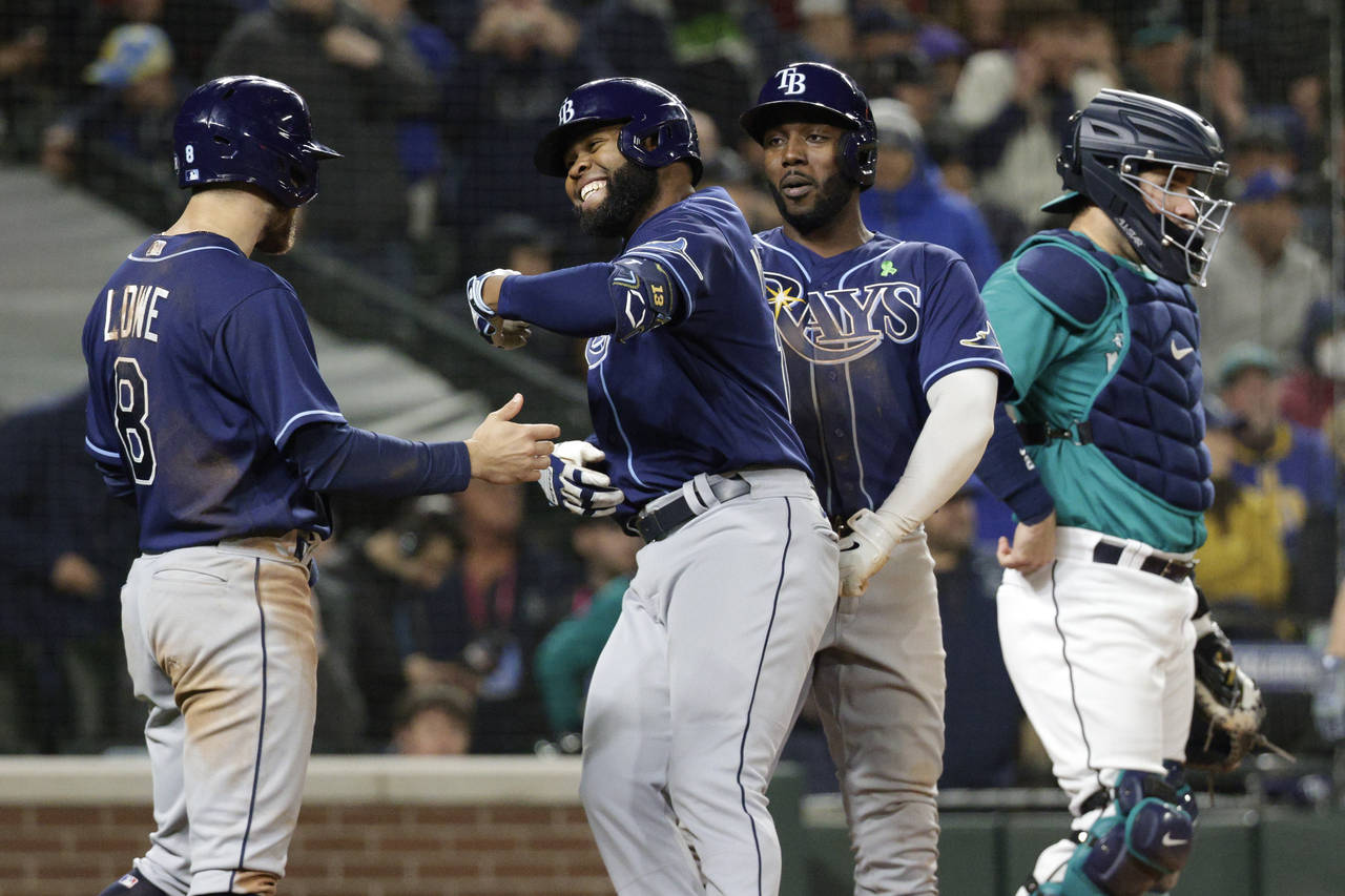 Tampa Bay Rays' Manuel Margot, second left, celebrates with teammates Brandon Lowe, left, and Randy...