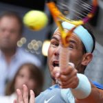 
              Rafael Nadal of Spain returns the ball to Miomir Kecmanovic of Serbia during their match at the Mutua Madrid Open tennis tournament in Madrid, Spain, Wednesday, May 4, 2022. (AP Photo/Paul White)
            