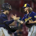 
              Milwaukee Brewers' Victor Caratini, left, high-fives Josh Hader after the final out a baseball game against the Cincinnati Reds in Cincinnati, Tuesday, May 10, 2022. The Brewers won 5-4. (AP Photo/Aaron Doster)
            