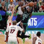 
              Boston Celtics' Jaylen Brown (7) passes off in front of Miami Heat's P.J. Tucker (17) during the first half of Game 6 of the NBA basketball playoffs Eastern Conference finals Friday, May 27, 2022, in Boston. (AP Photo/Michael Dwyer)
            