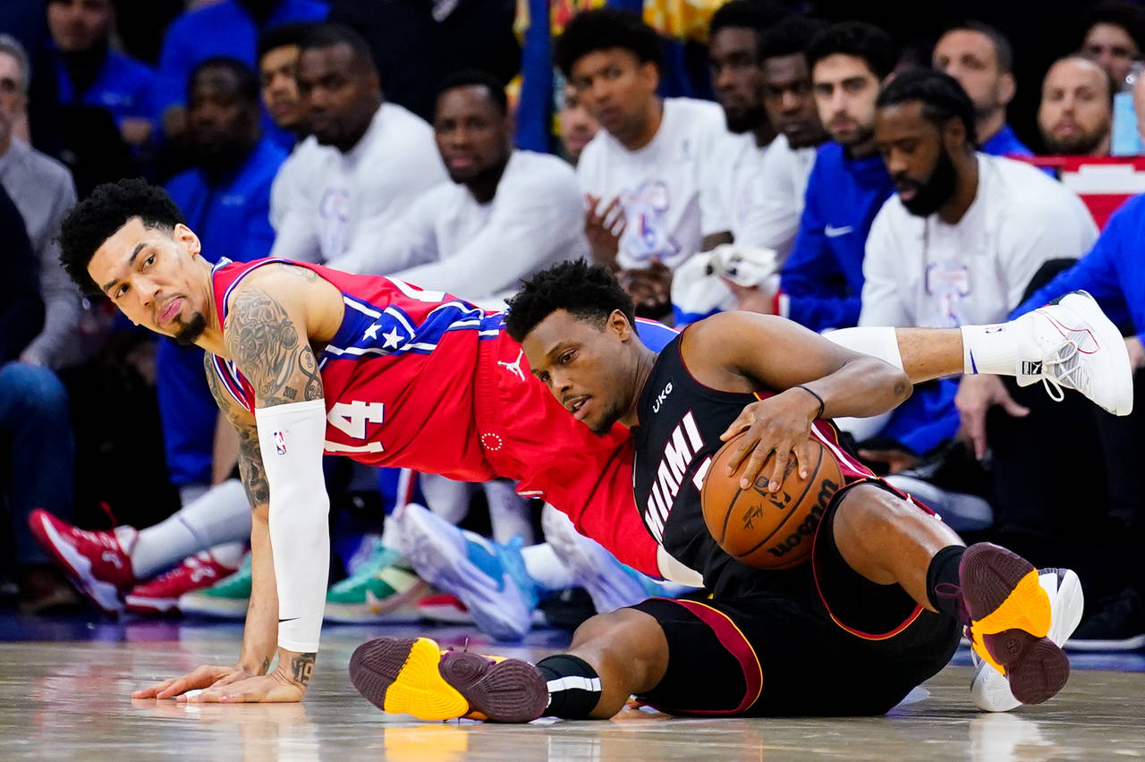 Miami Heat's Kyle Lowry, right, and Philadelphia 76ers' Danny Green battle for the ball during the ...