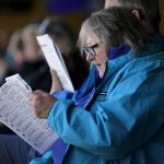
              Peggy Janiszewski looks over a race program at the Iowa Greyhound Park, Saturday, April 16, 2022, in Dubuque, Iowa. After the end of a truncated season in Dubuque in May, the track here will close. By the end of the year, there will only be two tracks left in the country. (AP Photo/Charlie Neibergall)
            
