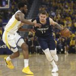 
              Dallas Mavericks guard Luka Doncic, right, drives to the basket against Golden State Warriors forward Andrew Wiggins during the first half of Game 2 of the NBA basketball playoffs Western Conference finals in San Francisco, Friday, May 20, 2022. (AP Photo/Jed Jacobsohn)
            