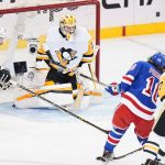 
              Pittsburgh Penguins goaltender Louis Domingue (70) stops a shot on goal by New York Rangers' Artemi Panarin (10) during the second period of Game 5 of an NHL hockey Stanley Cup first-round playoff series Wednesday, May 11, 2022, in New York. (AP Photo/Frank Franklin II)
            