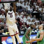 
              Miami Heat center Bam Adebayo (13) dunks the ball during the first half of Game 2 of the NBA basketball Eastern Conference finals playoff series against the Boston Celtics, Thursday, May 19, 2022, in Miami. (AP Photo/Lynne Sladky)
            