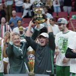 
              Boston Celtics managing partner and CEO Wycliffe Grousbeck raised the NBA Eastern Conference trophy after defeating the Miami Heat in Game 7 of the NBA basketball Eastern Conference finals playoff series, Sunday, May 29, 2022, in Miami. (AP Photo/Lynne Sladky)
            
