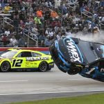 
              Ryan Blaney (12) passes by Ross Chastain (1) lifting off the track after making contact with Kyle Busch, right, during the NASCAR All-Star auto race at Texas Motor Speedway in Fort Worth, Texas, Sunday, May 22, 2022. (AP Photo/Randy Holt)
            