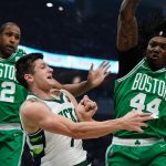 
              Milwaukee Bucks' Grayson Allen passes around Boston Celtics' Robert Williams III and Al Horford during the first half of Game 3 of an NBA basketball Eastern Conference semifinals playoff series Saturday, May 7, 2022, in Milwaukee. (AP Photo/Morry Gash)
            