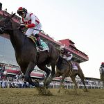 
              Jose Ortiz, left, atop Early Voting, edges out Joel Rosario, second from right, atop Epicenter, and Brian Hernandez Jr., right, atop Creative Minister, to win during the 147th running of the Preakness Stakes horse race at Pimlico Race Course, Saturday, May 21, 2022, in Baltimore. (AP Photo/Julio Cortez)
            