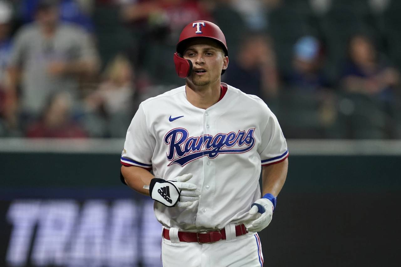 Texas Rangers' Corey Seager jogs to the dugout after hitting a solo home run in the third inning of...