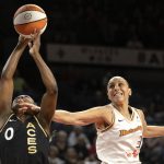 
              Phoenix Mercury guard Diana Taurasi (3) reaches to block a shot by Las Vegas Aces guard Jackie Young (0) during the first half of a WNBA basketball game Saturday, May 21, 2022, in Las Vegas. (AP Photo/Ellen Schmidt)
            