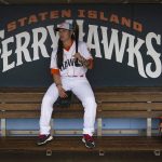 
              Kelsie Whitmore, a 23-year-old two-way player for the Atlantic League's Staten Island FerryHawks, sit in her team's dugout before gametime, Friday, May 13, 2022, in New York. Whitmore is one of the first women to be in the starting lineup and pitch relief with a professional team connected to Major League Baseball. (AP Photo/Bebeto Matthews)
            