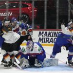 
              Germany's and Slovakia's players challenge in front of Slovakia's keeper Patrik Rybar during the group A Hockey World Championship match between Slovakia and Germany in Helsinki, Finland, Saturday May 14, 2022. (AP Photo/Martin Meissner)
            