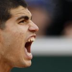 
              Spain's Carlos Alcaraz shouts as he wins the fourth set against Spain's Albert Ramos-Vinolas during their second round match of the French Open tennis tournament at the Roland Garros stadium Wednesday, May 25, 2022 in Paris. (AP Photo/Jean-Francois Badias)
            