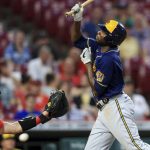 
              Cincinnati Reds' Tyler Stephenson, left, attempts to field the ball as Milwaukee Brewers' Lorenzo Cain reacts to being hit by a pitch during the sixth inning of a baseball game in Cincinnati, Tuesday, May 10, 2022. (AP Photo/Aaron Doster)
            