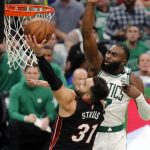 
              Miami Heat's Max Strus (31) shoots against Boston Celtics' Jaylen Brown (7) during the second half of Game 3 of the NBA basketball Eastern Conference finals playoff series Saturday, May 21, 2022, in Boston. (AP Photo/Michael Dwyer)
            