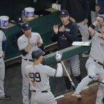 
              New York Yankees' Aaron Judge (99) celebrates his solo home run off Baltimore Orioles starting pitcher Spenser Watkins with teammates including Josh Donaldson, right, during the third inning of a baseball game, Tuesday, May 17, 2022, in Baltimore. (AP Photo/Julio Cortez)
            