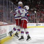 
              New York Rangers' Chris Kreider, left, celebrates his goal against the Carolina Hurricanes with teammate Adam Fox (23) during the third period of Game 7 of an NHL hockey Stanley Cup second-round playoff series in Raleigh, N.C., Monday, May 30, 2022. (AP Photo/Karl B DeBlaker)
            