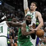 
              Boston Celtics' Jaylen Brown is fouled between Milwaukee Bucks' Jrue Holiday and Brook Lopez during the second half of Game 3 of an NBA basketball Eastern Conference semifinals playoff series Saturday, May 7, 2022, in Milwaukee. The Bucks won 103-101 to take a 2-1 lead in the series. (AP Photo/Morry Gash)
            