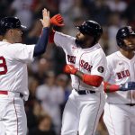Boston Red Sox's Jackie Bradley Jr., center, celebrates his three-run home run that scored J.D. Martinez (28) and Franchy Cordero, right, during the eighth inning of a baseball game against the Seattle Mariners, Friday, May 20, 2022, in Boston. (AP Photo/Michael Dwyer)